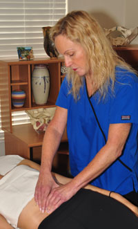 An image of Belinda Wurn treating a patient with back pain.
